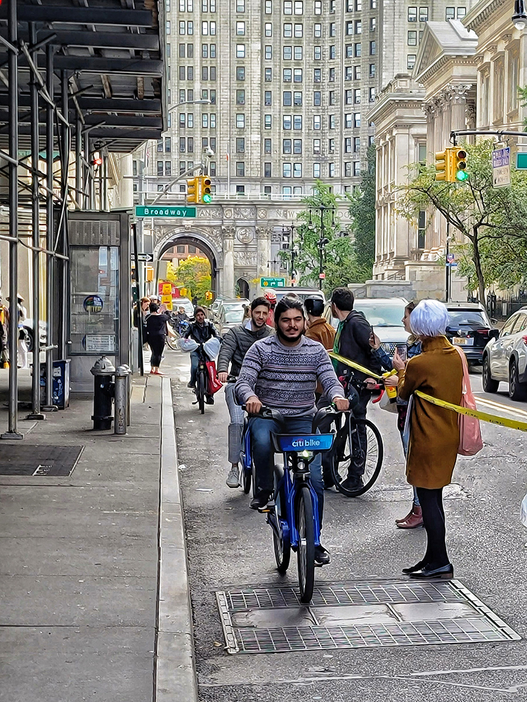Cyclists riding through our human-protected bike lane